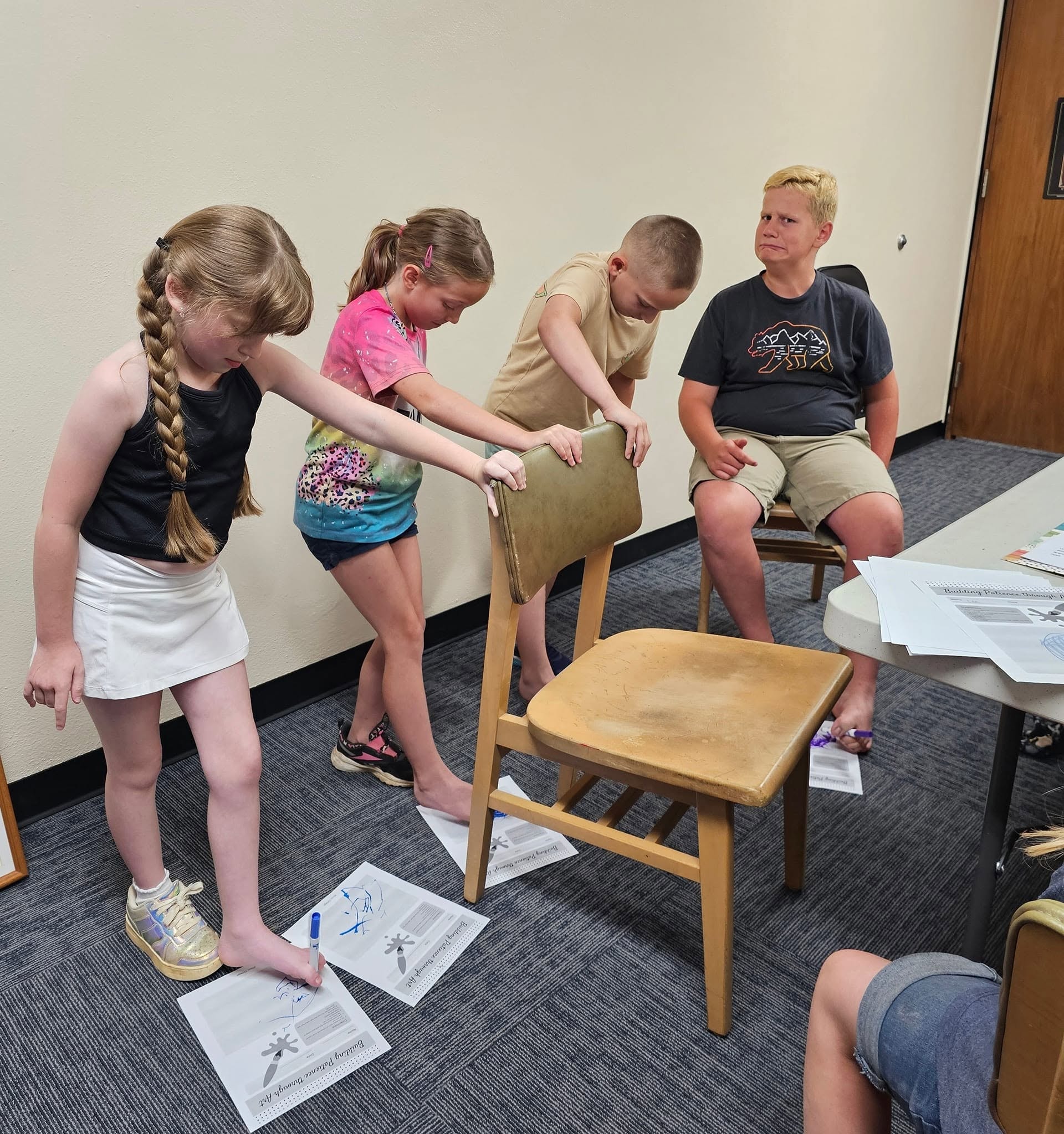 Students working together on a chair activity during class
