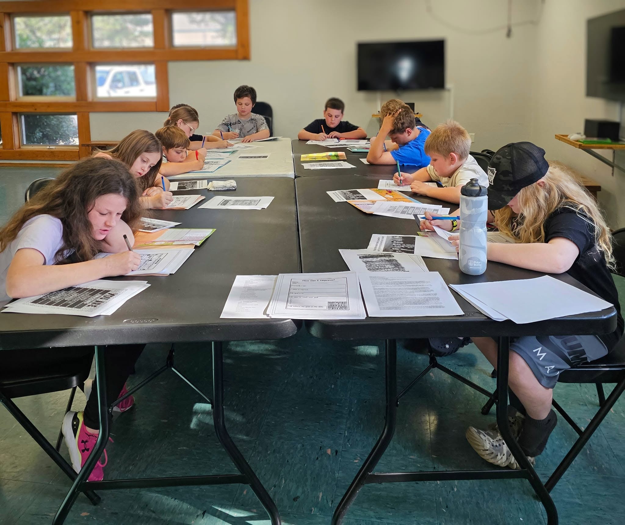 Full class of students working on etiquette worksheets