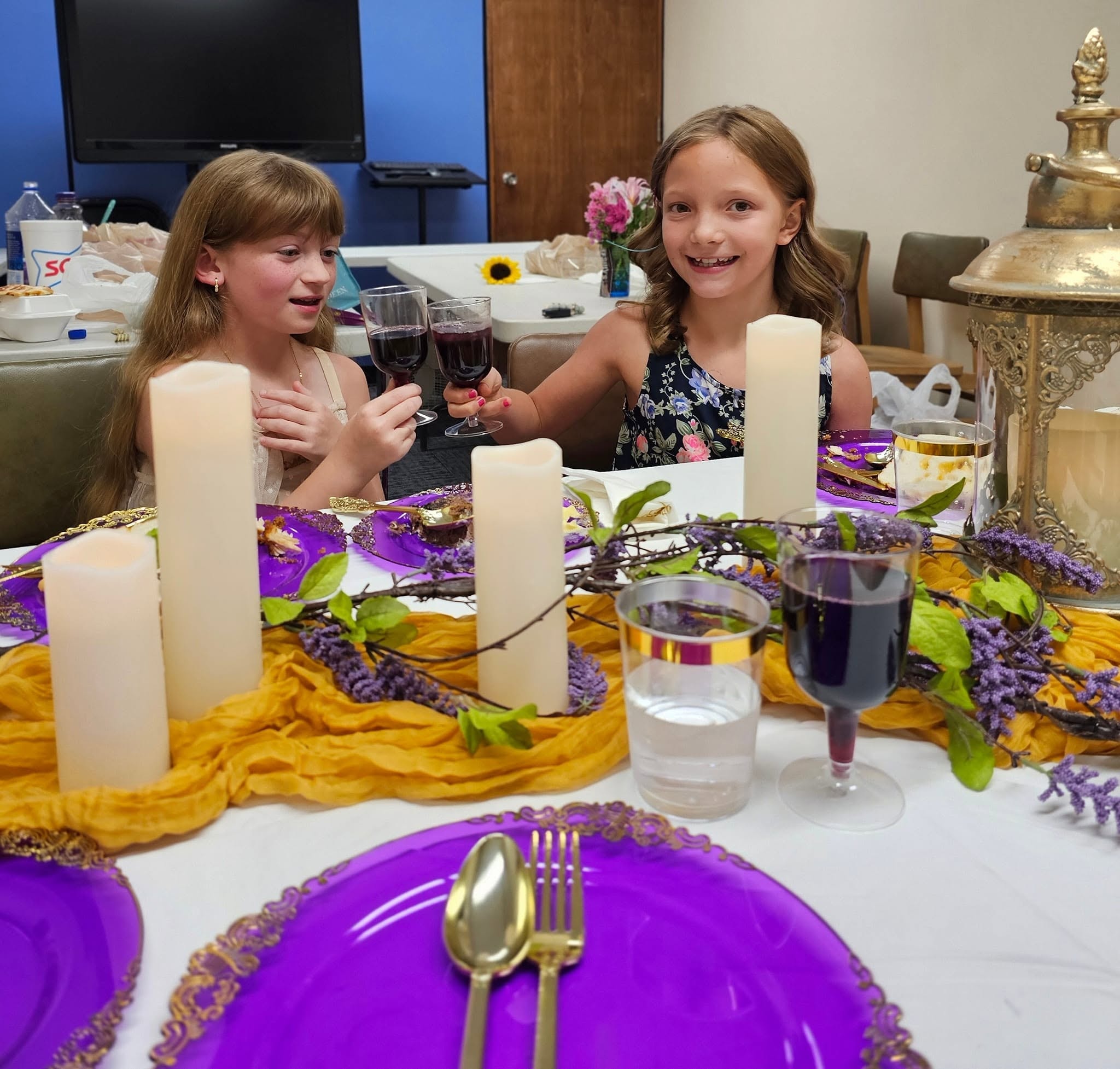 Two girls toasting at the formal etiquette dinner